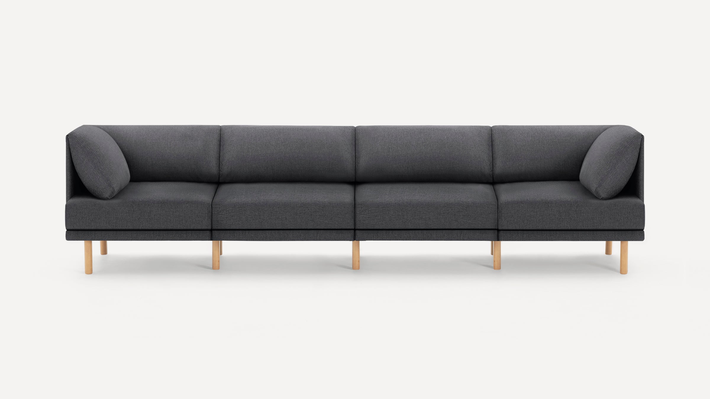 Modern dark gray fabric sectional sofa with wooden legs and cushioned armrests on each end, minimalist design.