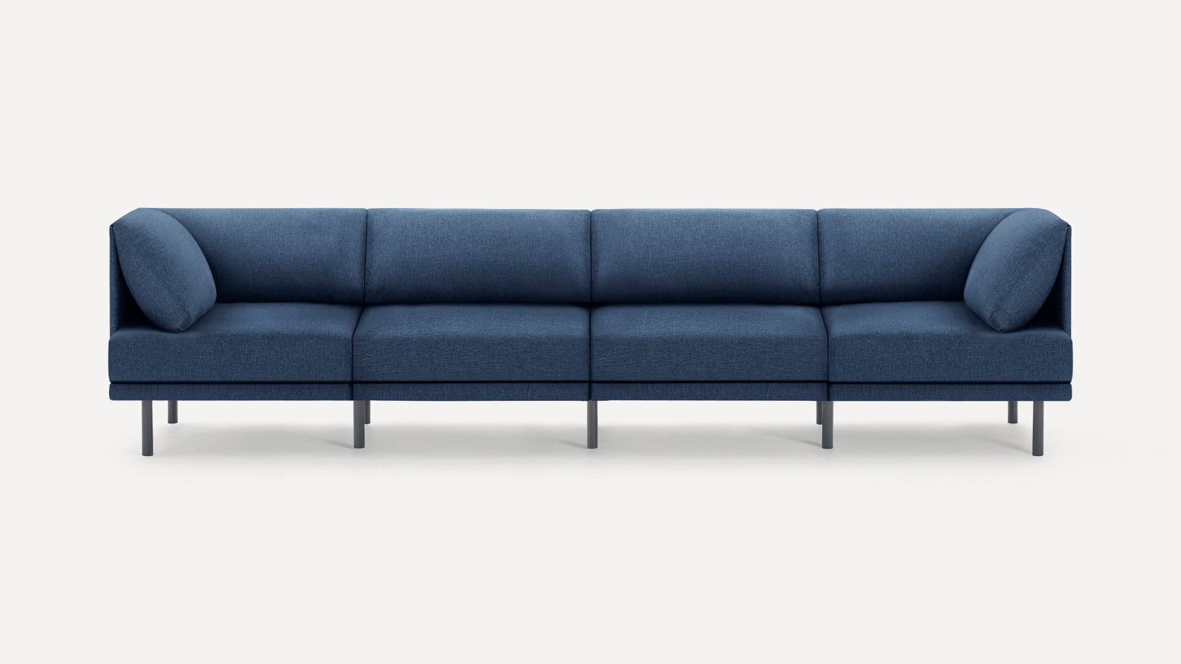 Modern, minimalist navy blue sectional sofa with clean lines, low backrests, and slim black metal legs on light background.