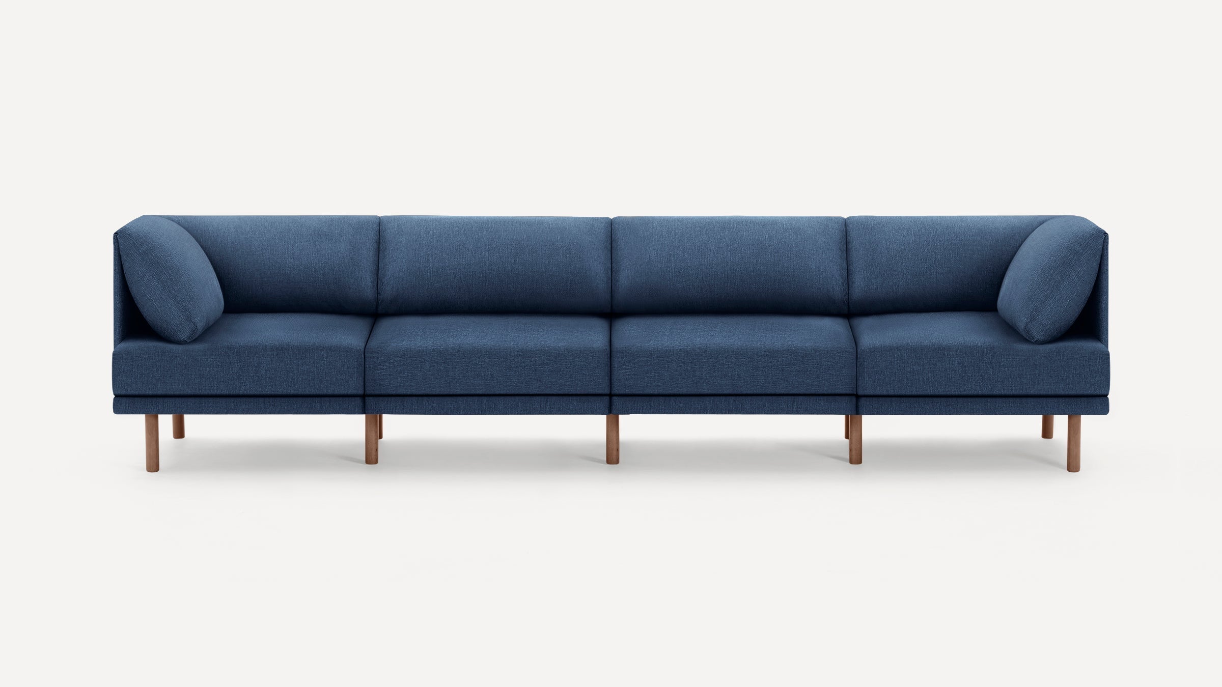 Modern navy blue sectional sofa with wooden legs, featuring clean lines and soft cushions on a white background.