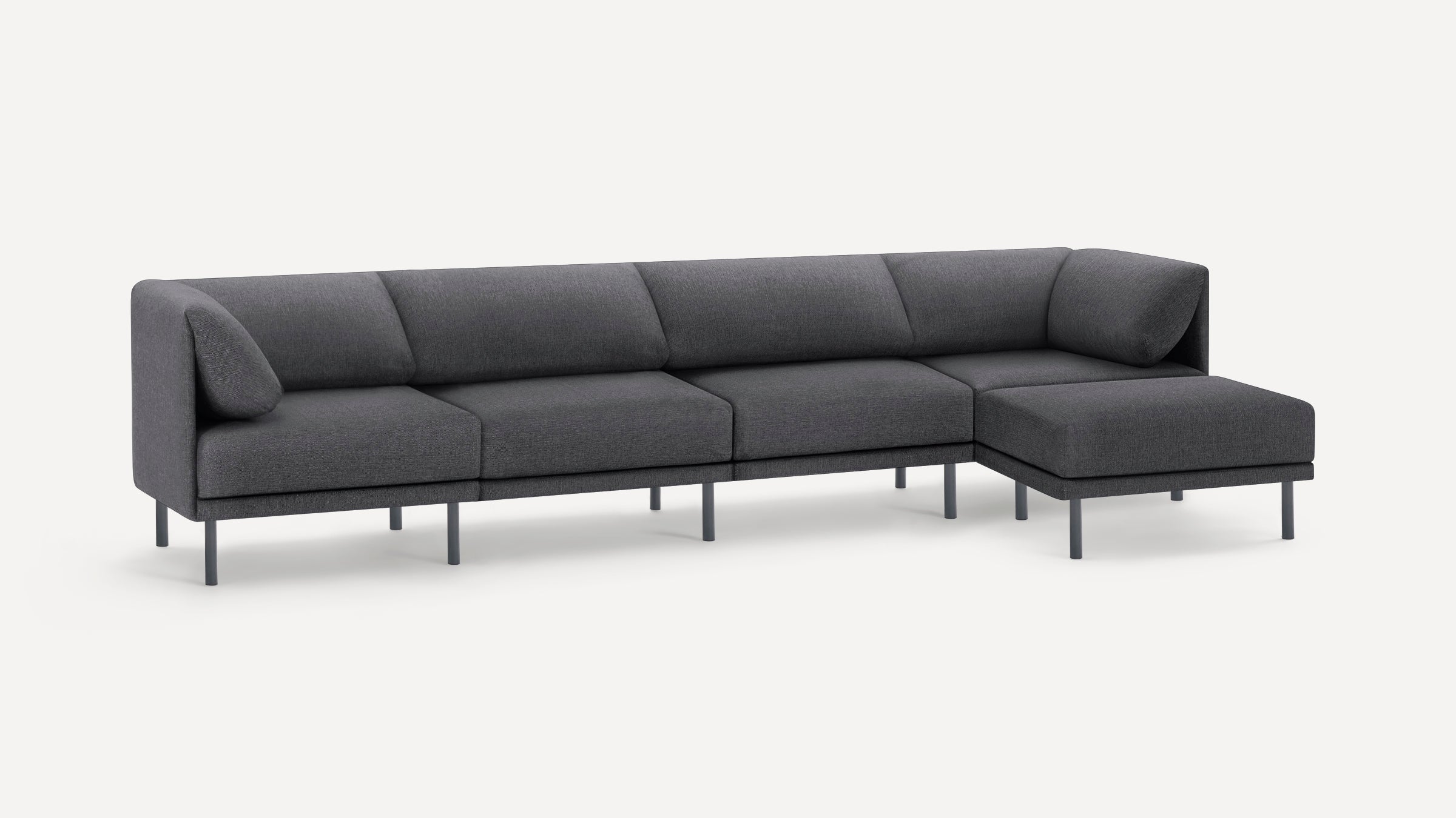 Modern dark gray sectional sofa with five seats and clean metal legs, featuring plush angled cushions on each end.