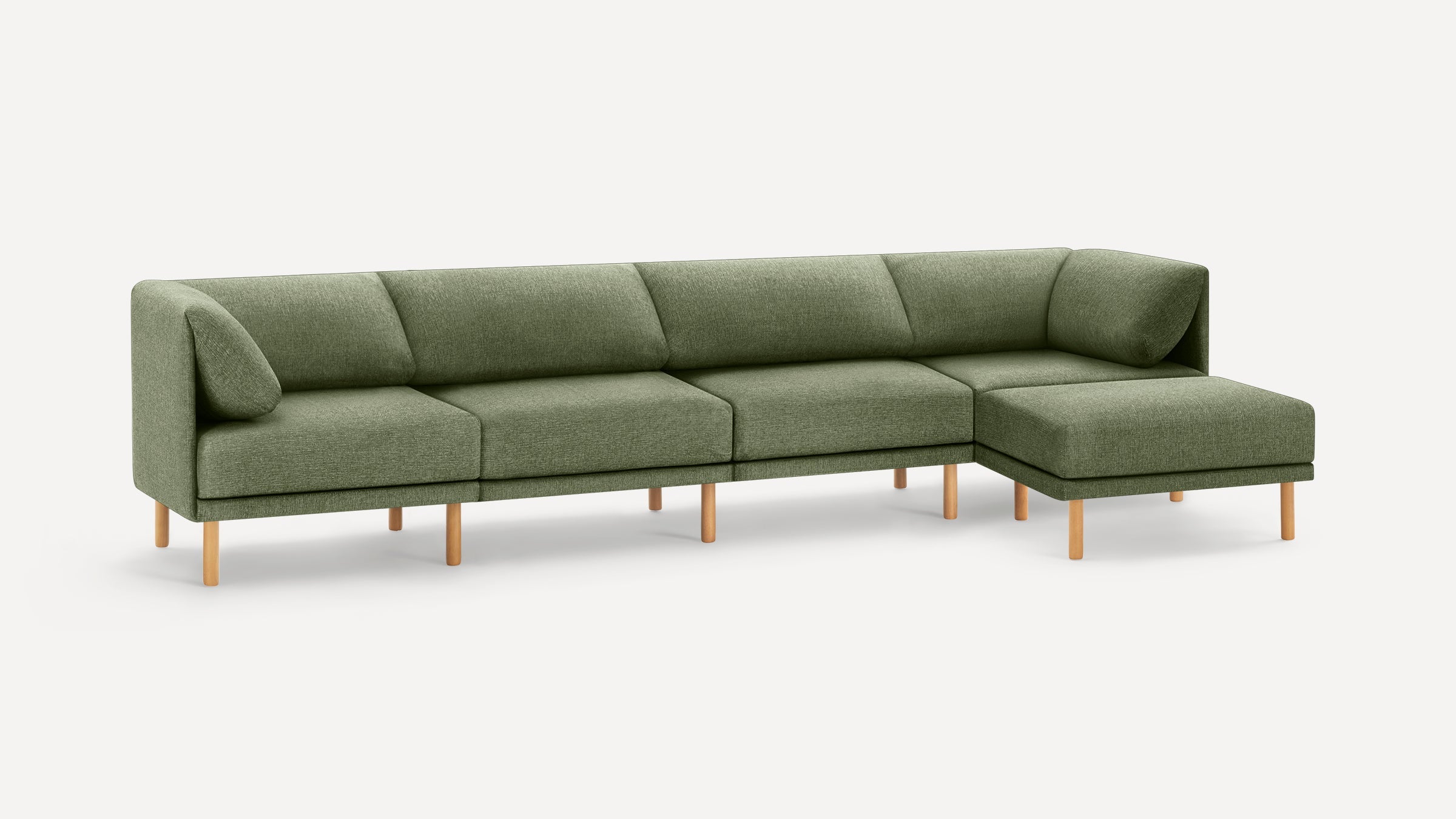 Modern sectional sofa in sage green upholstery with wooden legs, featuring a chaise lounge on the right side.