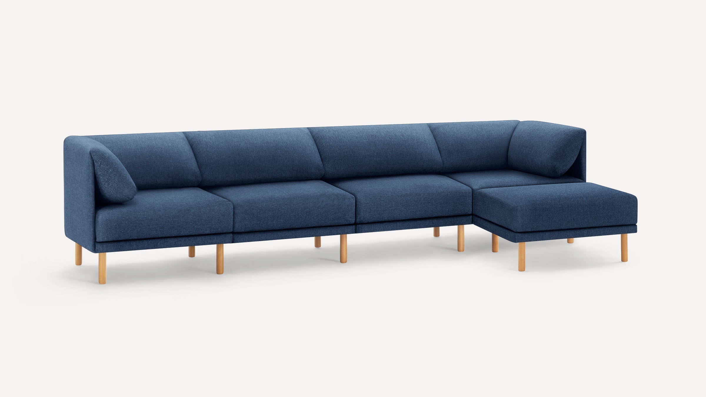 Modern sectional sofa with blue fabric upholstery, wooden legs, and a right-side chaise lounge.