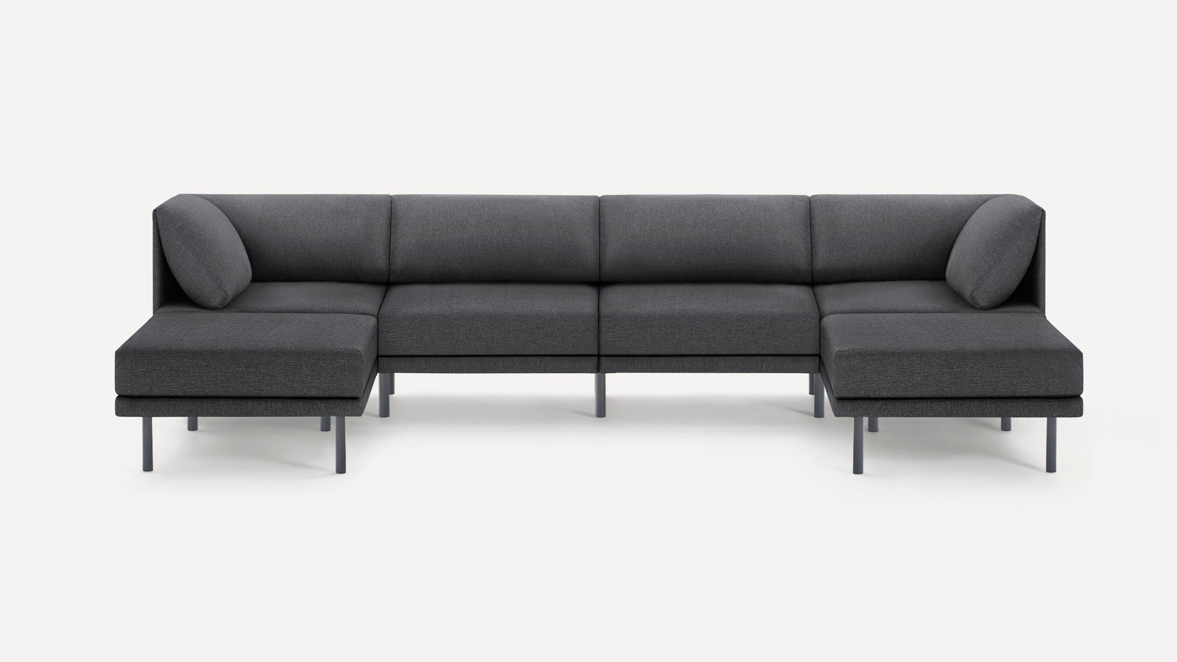 Dark gray modern sectional sofa with low backrest, slim legs, and corner cushions, designed for spacious seating.