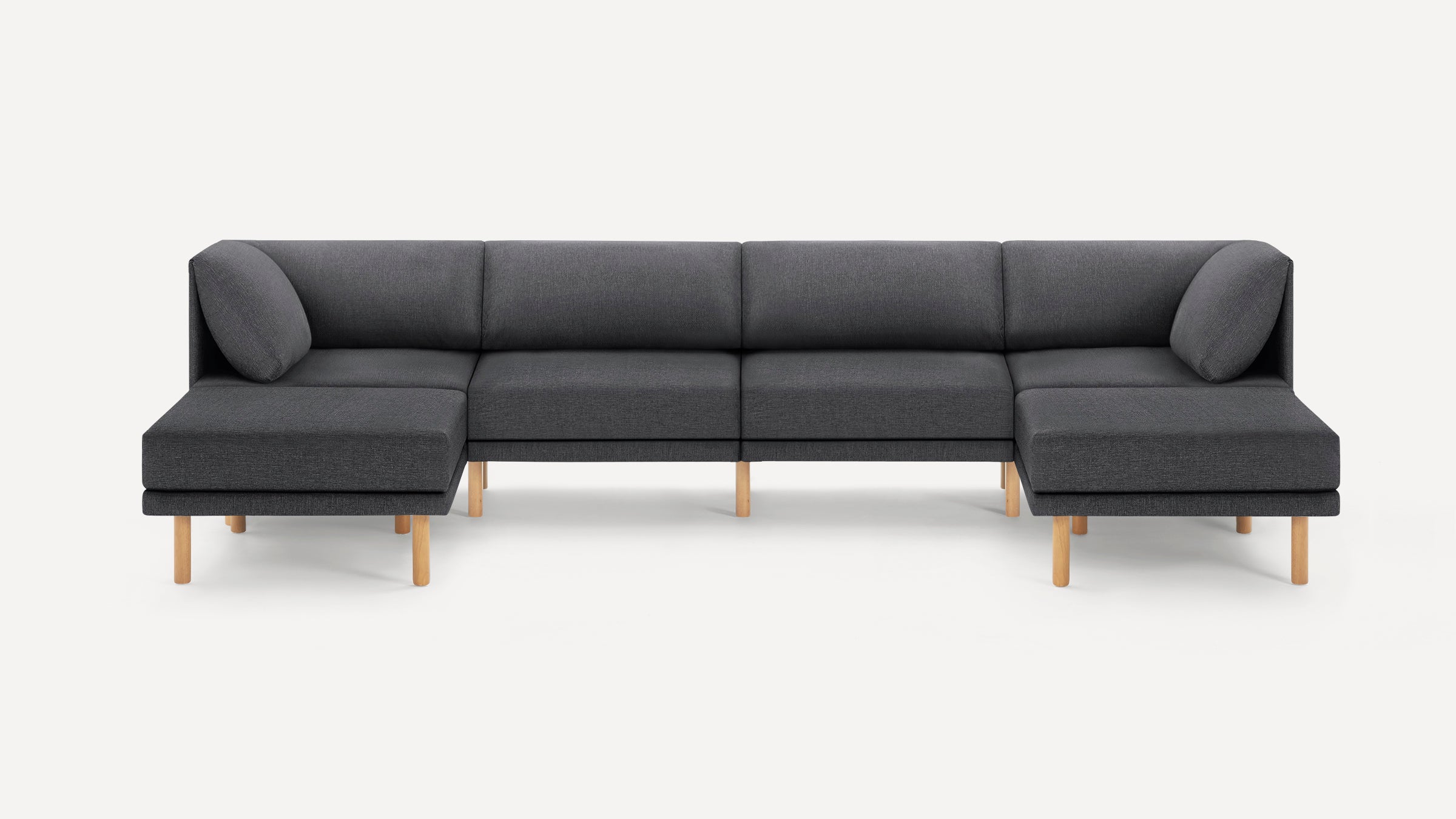 Modern dark gray fabric sectional sofa with wooden legs, featuring a symmetrical L-shaped design with back cushions.