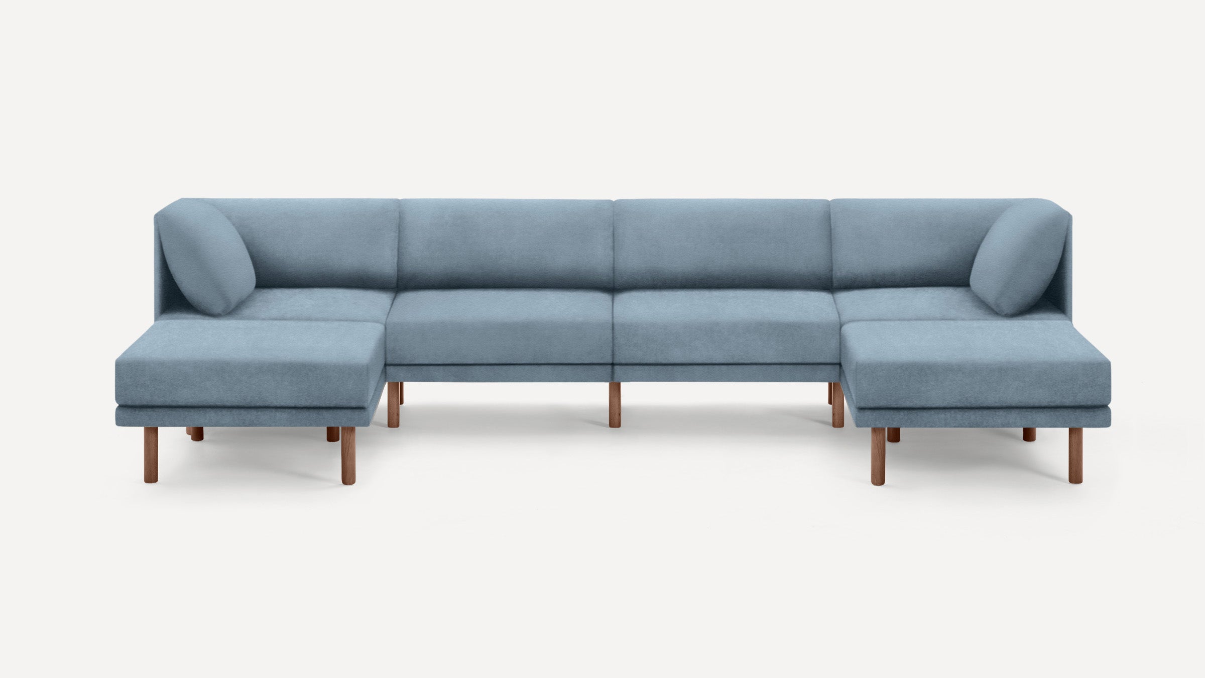 Modern light blue sectional sofa with wooden legs, featuring two cushioned ends and a low-profile backrest.