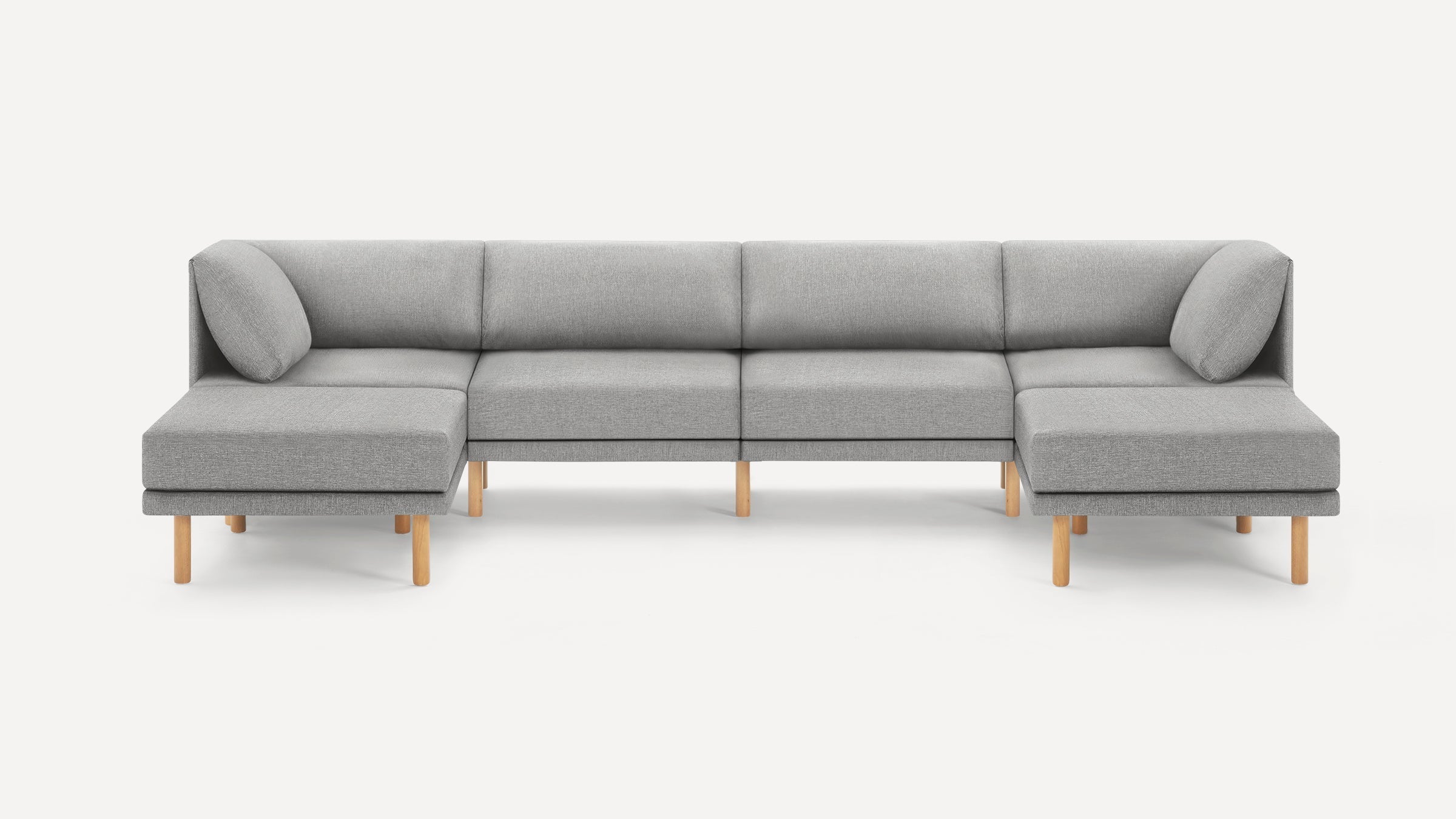 Modern grey sectional sofa with light wooden legs, featuring two corner seats with cushions and a minimalist design.