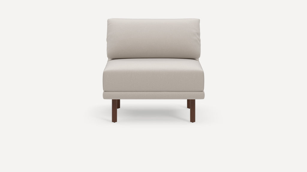 Modern beige armless lounge chair with cushioned backrest and seat, supported by four dark wooden legs.