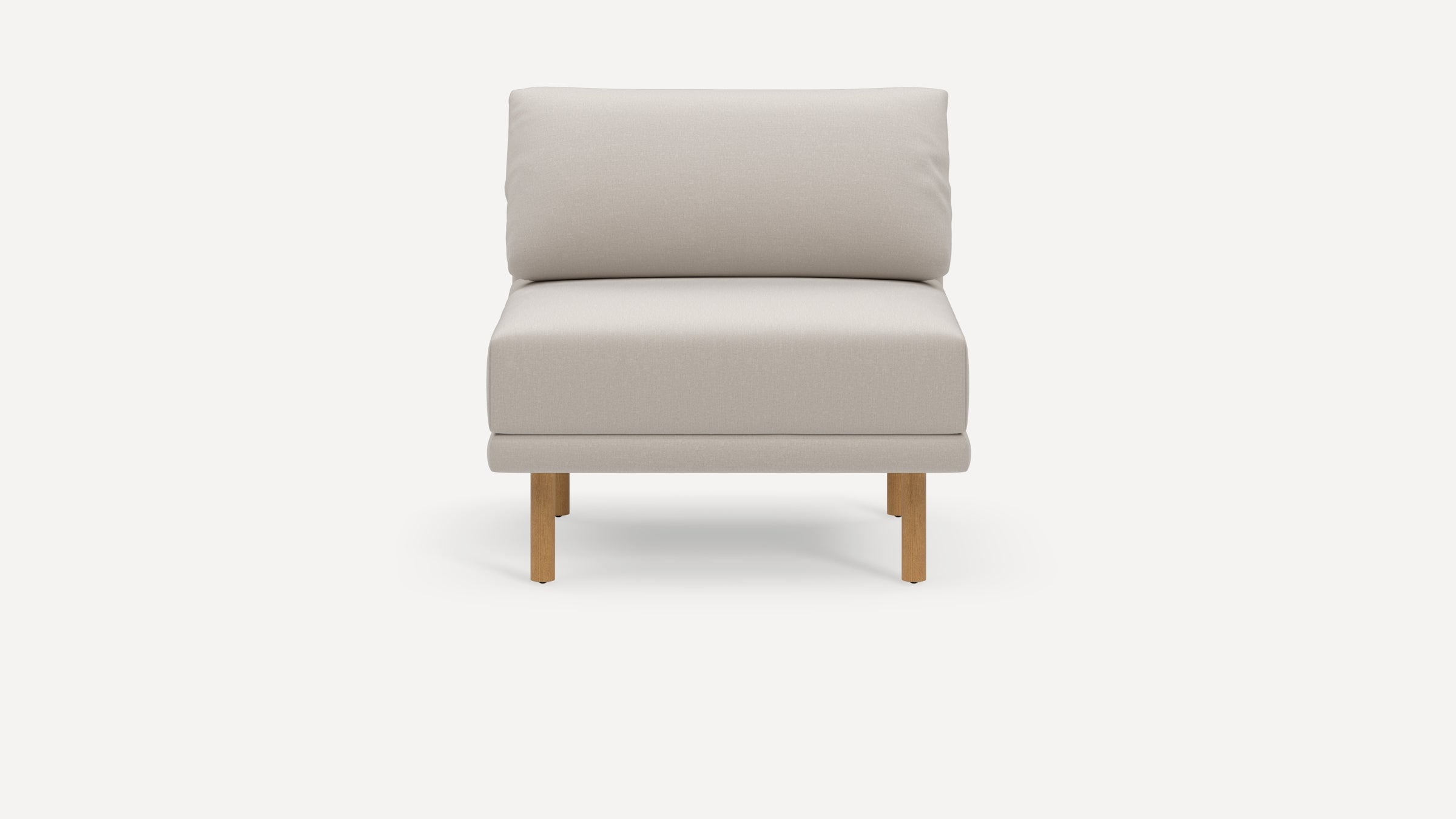 Front view of a modern beige cushioned armless chair with wooden legs on a white background.