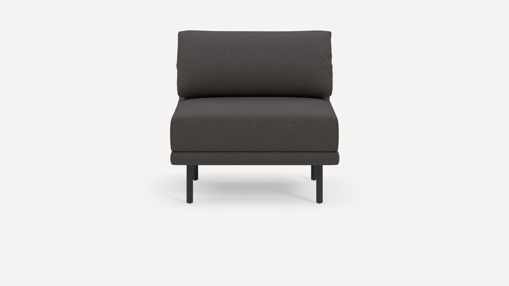 Front view of a modern, dark gray armless lounge chair with a cushioned backrest and metal legs.