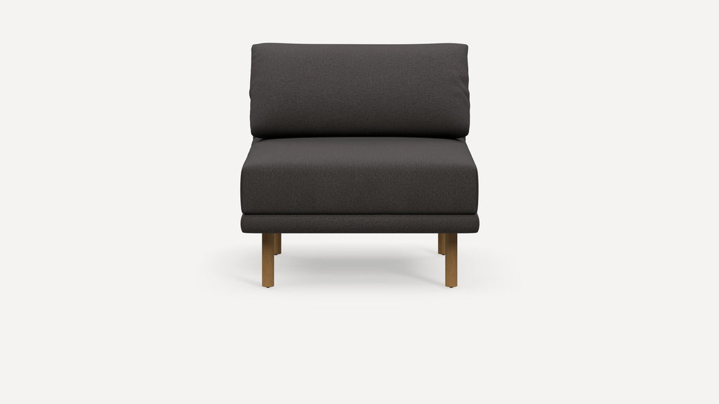 Front view of a modern armless lounge chair with dark gray fabric and wooden legs on a white background.