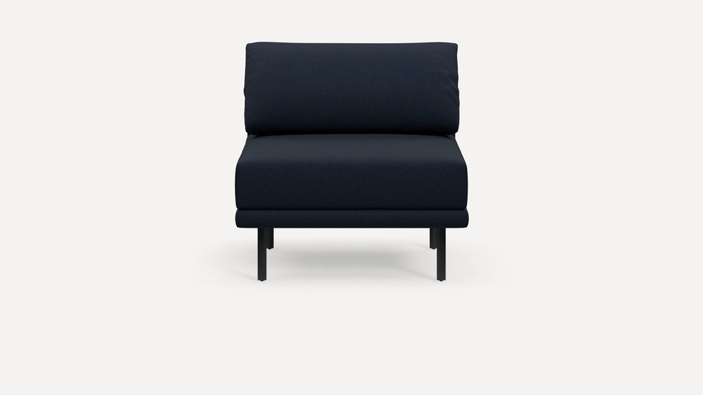 Front view of a modern dark navy blue upholstered armless lounge chair with slim black metal legs on a white background.