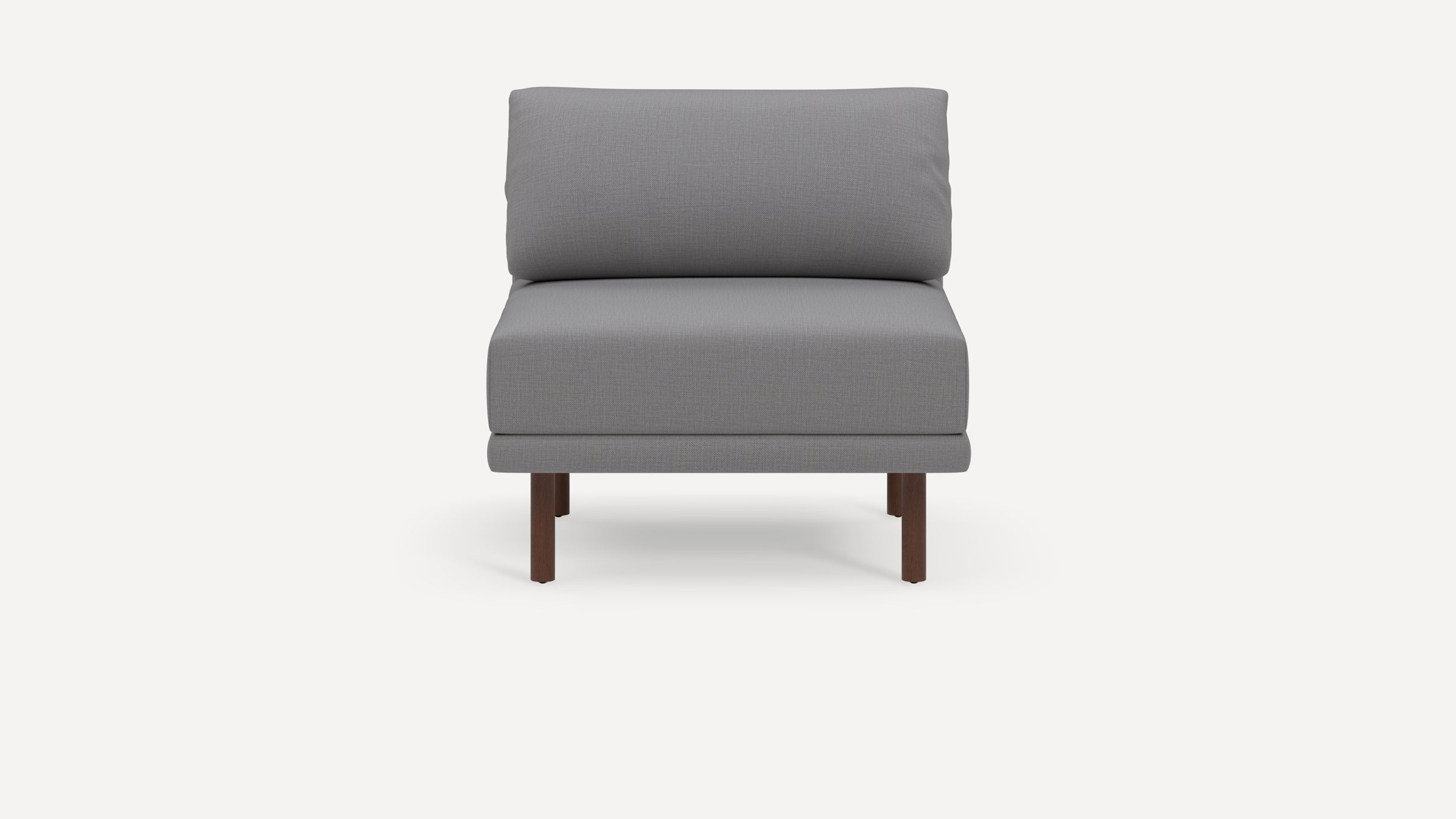 Modern armless grey cushioned chair with wooden legs, featuring a simple, minimalist design on a plain white background.