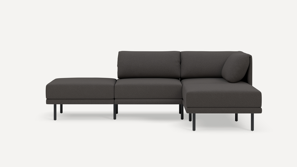 Modern dark gray sectional sofa with metal legs, featuring a left chaise and plush cushions, against a white background.