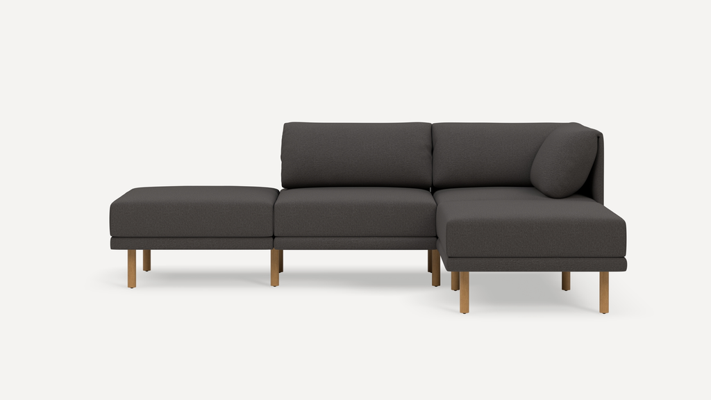 Modern dark gray sectional sofa with wooden legs, featuring three seating sections and cushioned backrests on a white background.