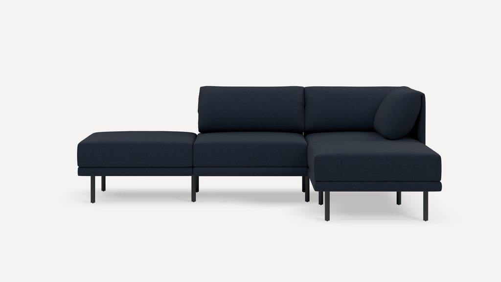 Modern modular navy blue fabric sofa with black metal legs, featuring a sectional design including a chaise lounge.