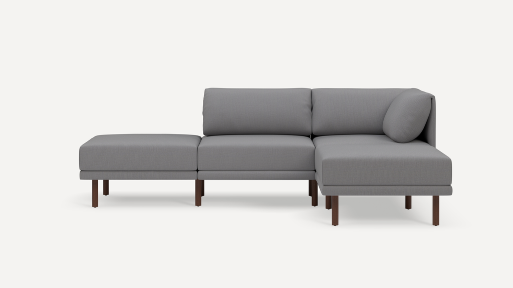 Modern grey sectional sofa with wooden legs, featuring a right-side chaise lounge and plush cushions.