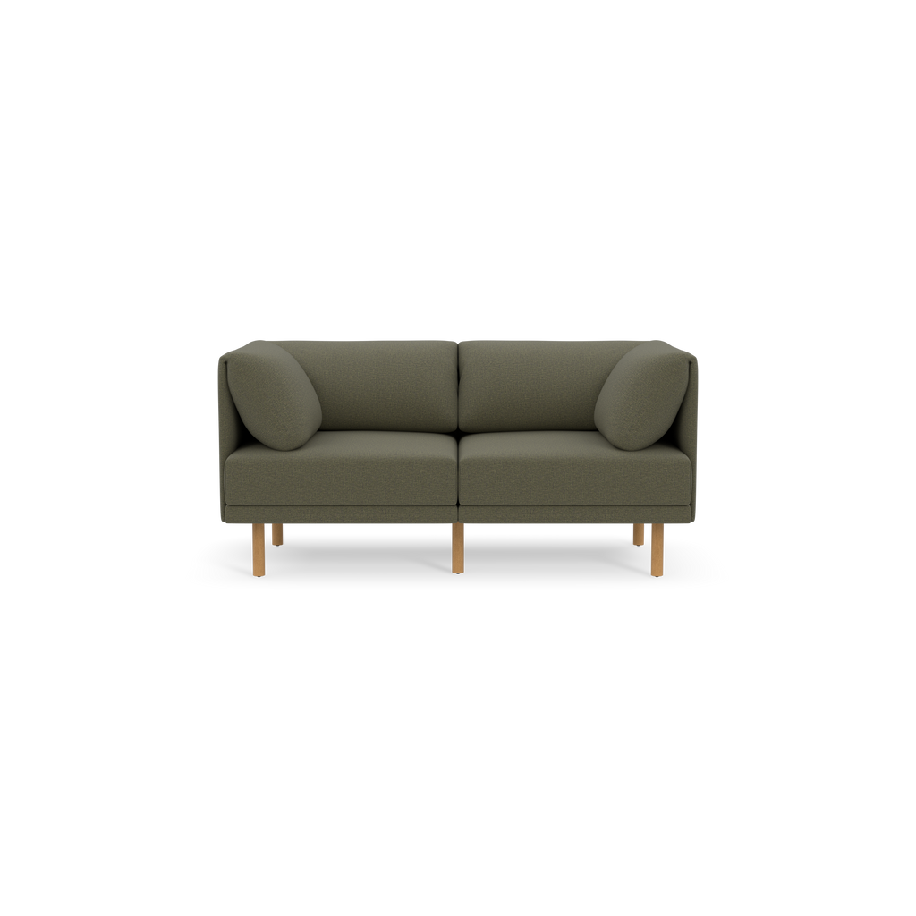 Front view of a modern Moss green two-seater sofa with rounded cushions and light wooden legs against black background.