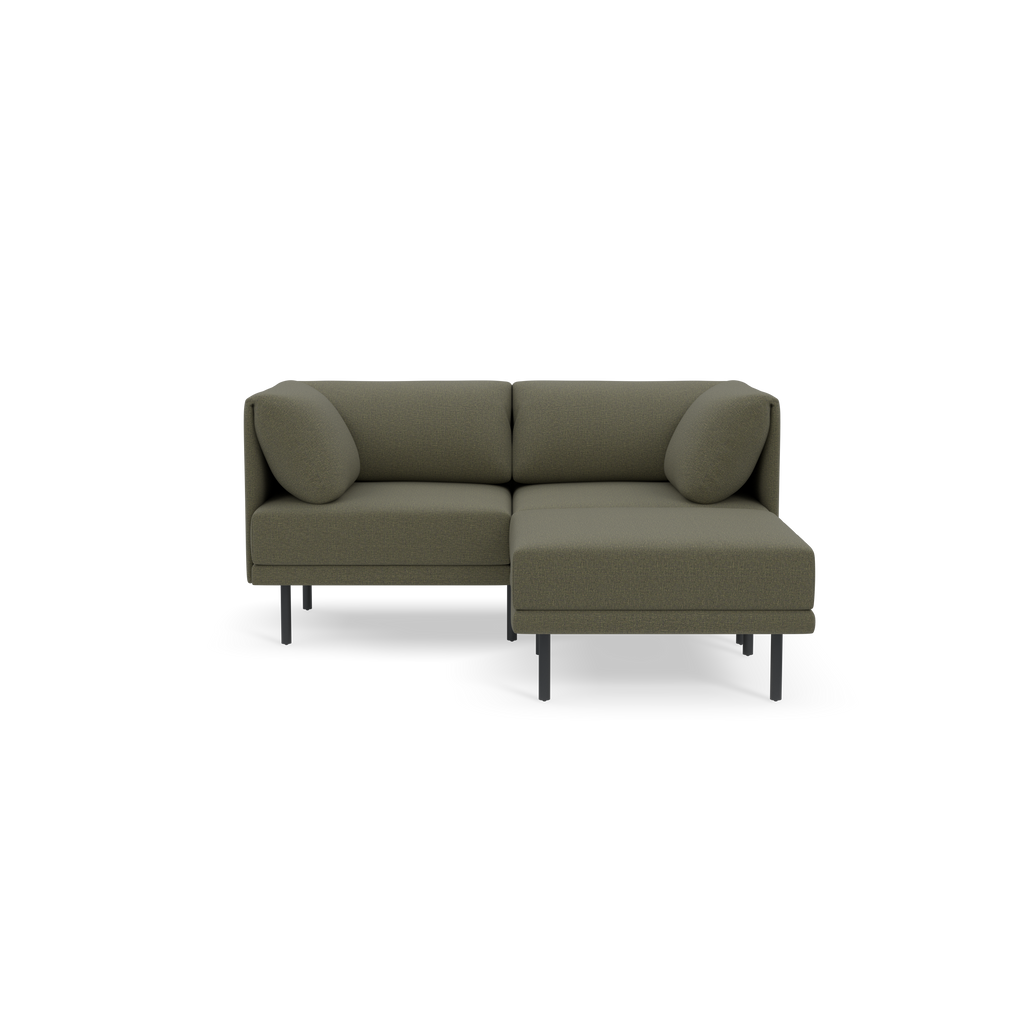 Modern Moss green L-shaped sectional sofa with low backrest, cushioned seats, round pillows, and black metal legs on black background.