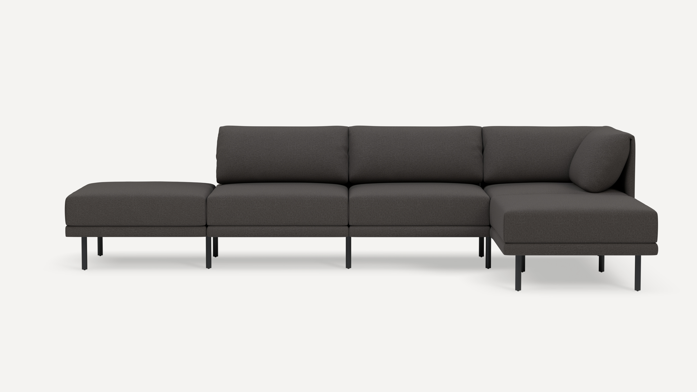 Modern dark gray sectional sofa with a left-side ottoman and right-side chaise, supported by slim black metal legs.