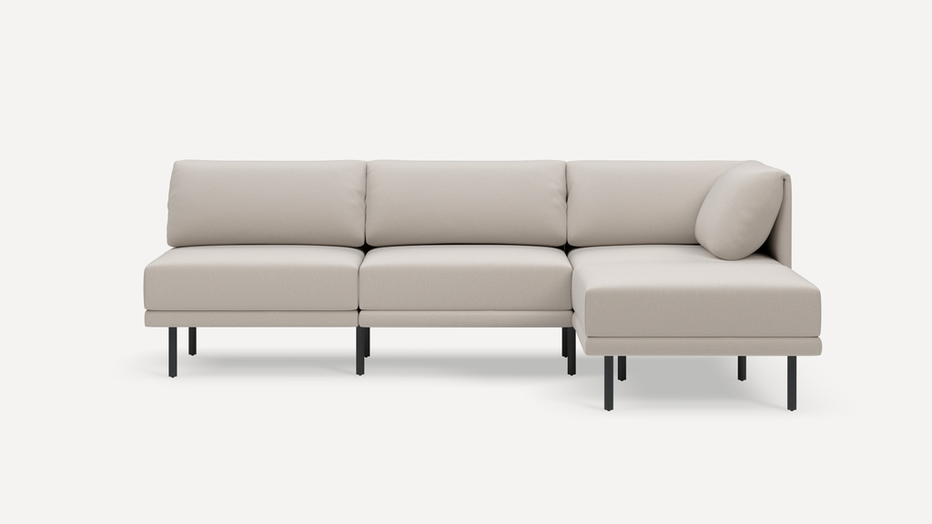 Modern beige sectional sofa with clean lines, black metal legs, and plush cushions, featuring a right-side chaise lounge.