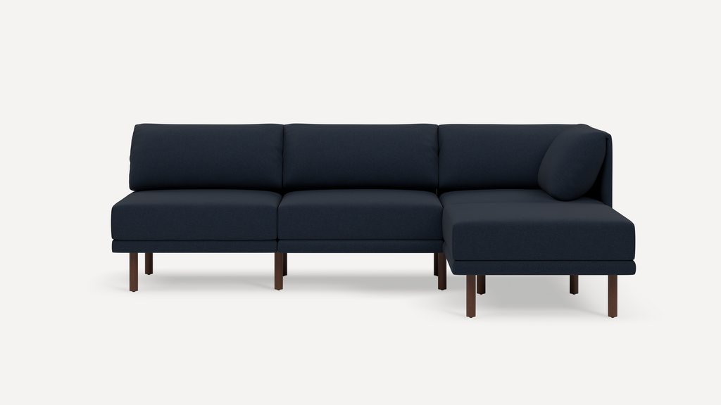 Modern navy blue sectional sofa with clean lines, wood legs, and a right-side chaise lounge, set against a white background.