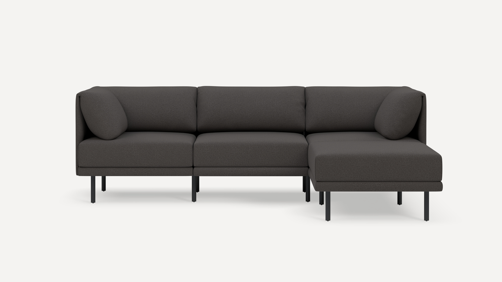 Modern dark gray sectional sofa with clean lines, cushioned seats and backs, and slim black metal legs on a white background.