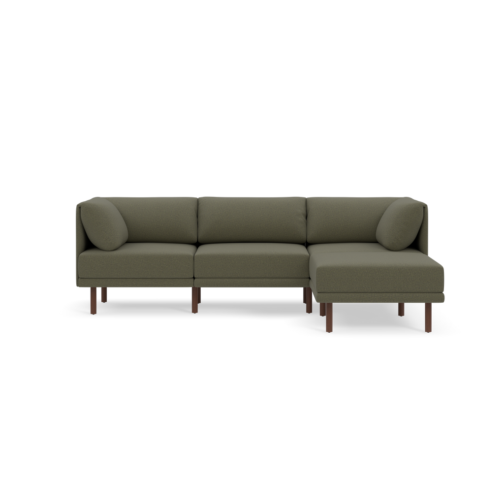 Modern Moss green sectional sofa with wooden legs and detachable rounded arm pillows, set against a black background.