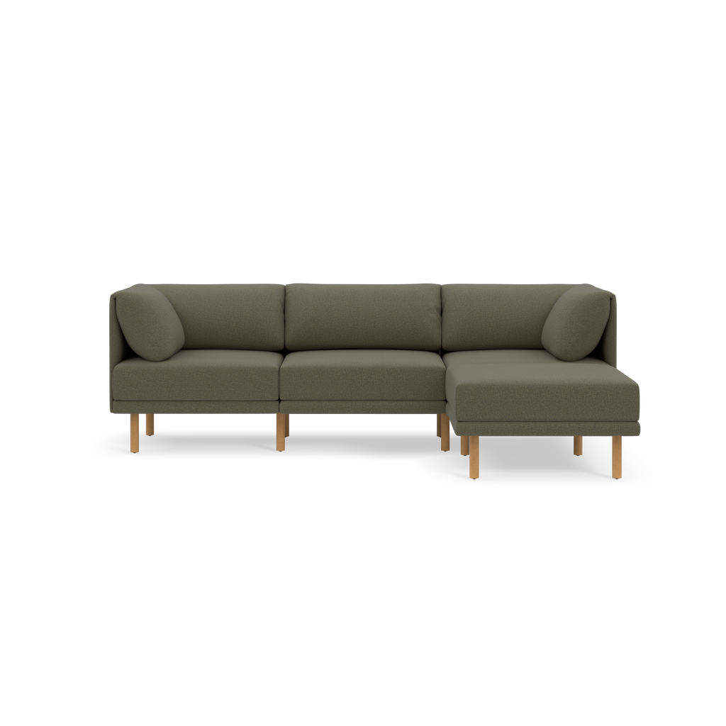 Modern Moss green sectional sofa with wooden legs, three seat cushions, two round side pillows, and a right-facing chaise lounge.