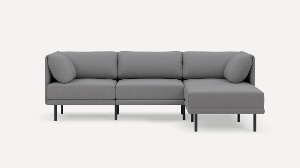 Modern gray L-shaped sectional sofa with clean lines, plush cushions, and slim black metal legs on white background.