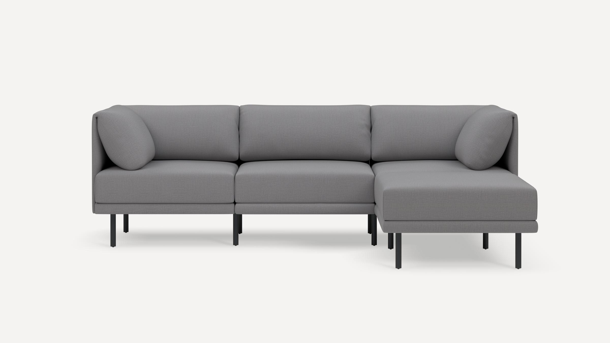 Modern gray L-shaped sectional sofa with clean lines, plush cushions, and slim black metal legs on white background.