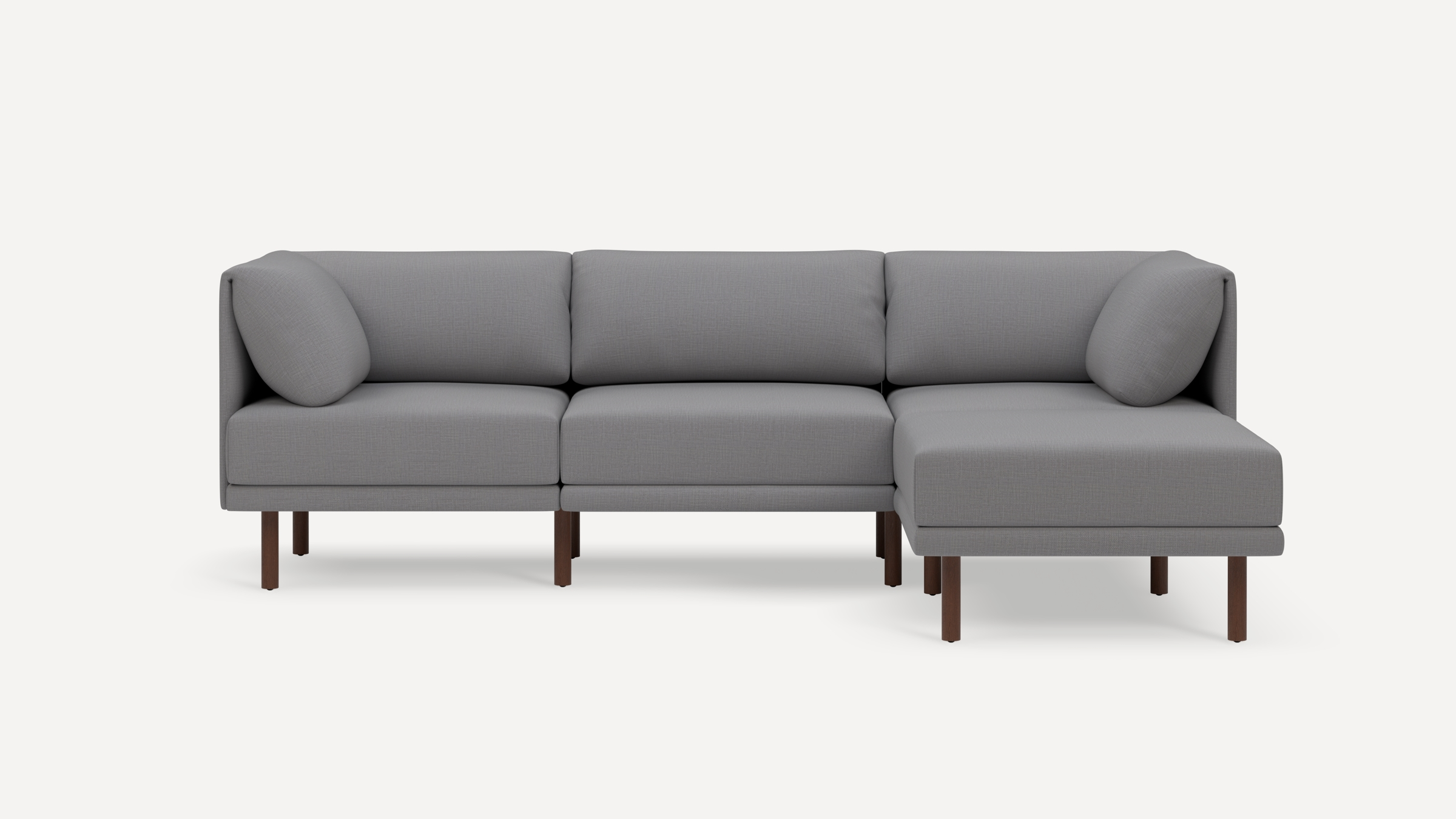 Modern gray sectional sofa with wooden legs, featuring clean lines and plush cushions, designed for comfortable seating.