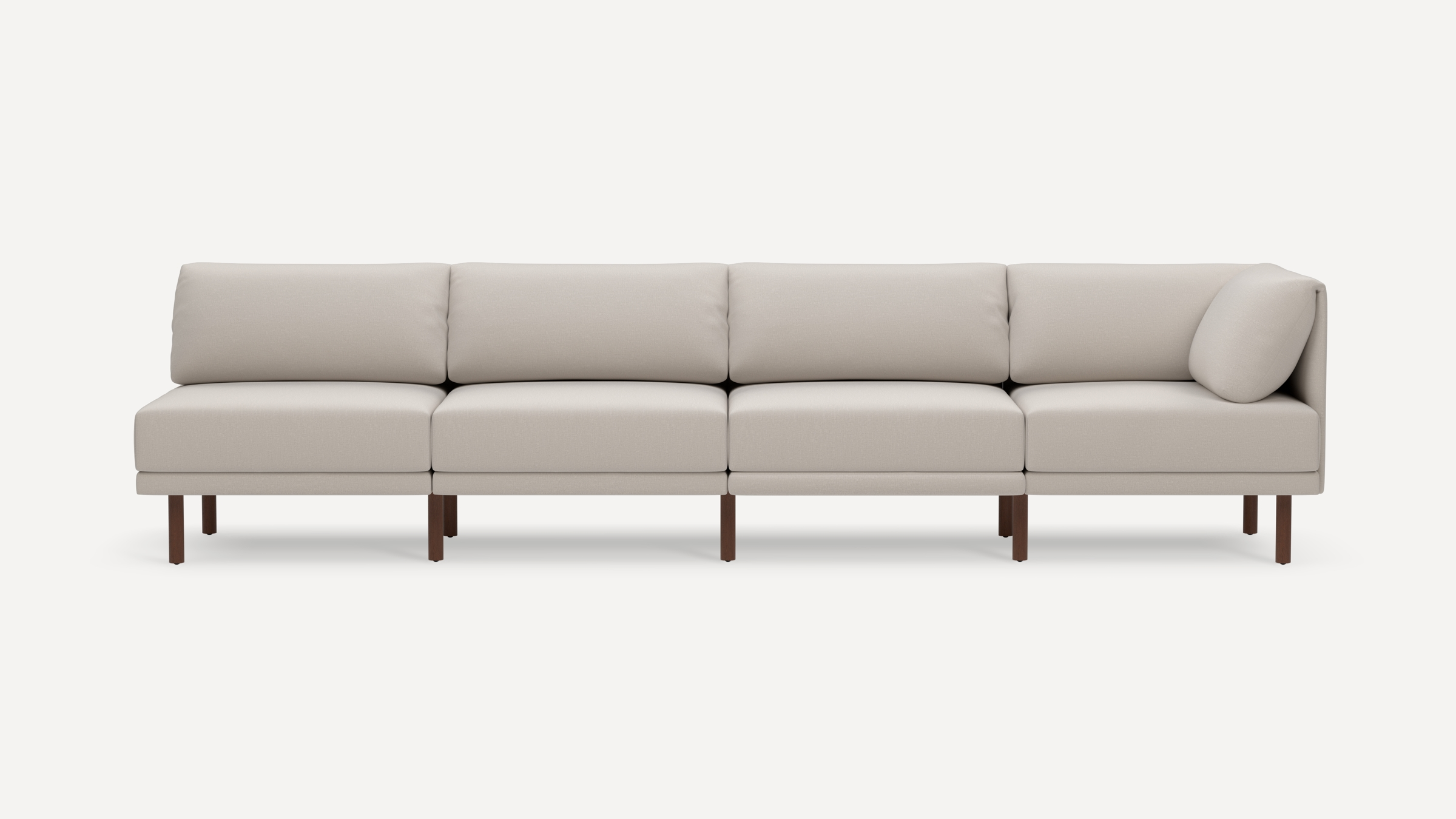 Modern four-seat sectional sofa with beige upholstery and wooden legs, featuring clean lines and plush back cushions.