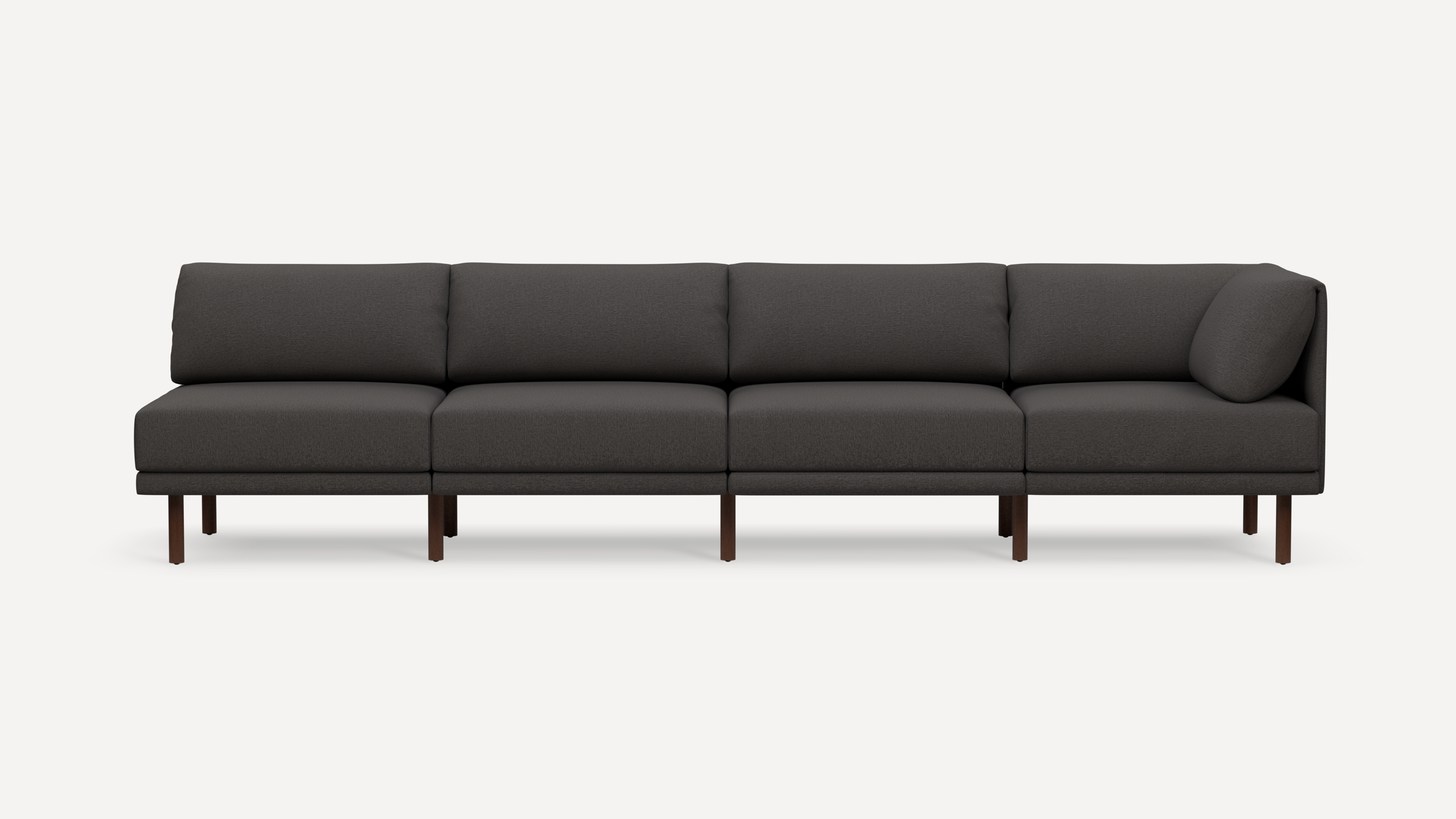 Modern dark gray sectional sofa with four cushioned seats, wooden legs, and a corner backrest pillow.