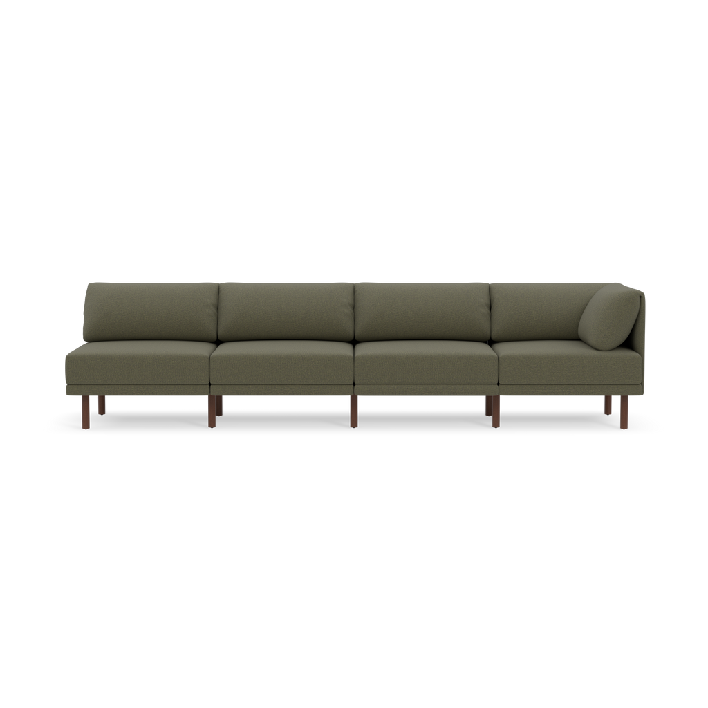 Long modern olive-green sectional sofa with wooden legs and low back cushions, minimalistic design.