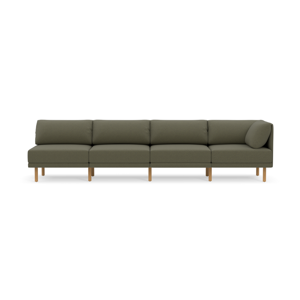Long modern modular sofa with Moss green fabric upholstery and wooden legs, featuring straight back cushions and one angled side cushion.