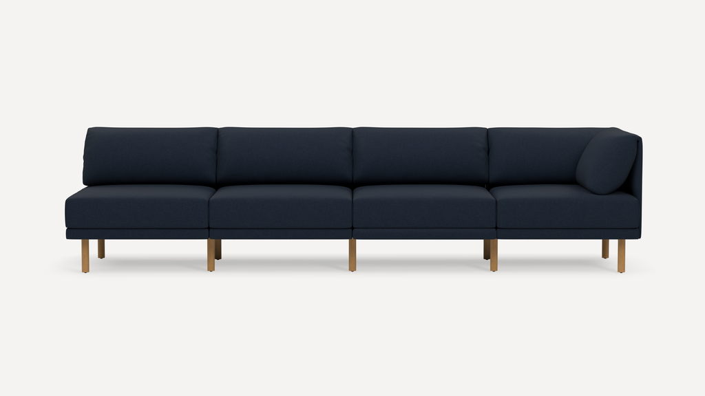 Modern navy blue sectional sofa with clean lines, wooden legs, and cushioned backrests, shown on white background.