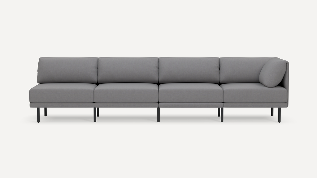 Modern gray four-seater sofa with slim black metal legs and cushioned backrest, featuring a right-side armrest cushion.