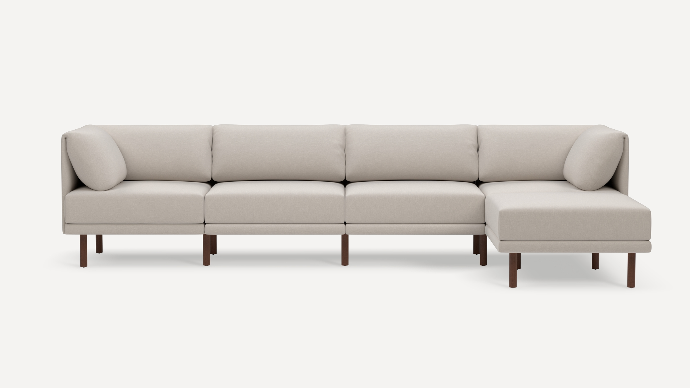 Modern beige sectional sofa with clean lines, wooden legs, and cushioned backrest and armrest pillows.