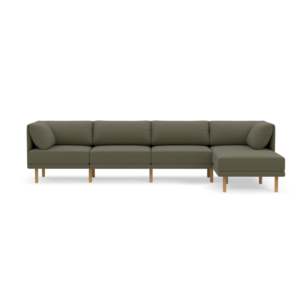Modern Moss green sectional sofa with wooden legs, featuring three cushions and an extended chaise on the right side.