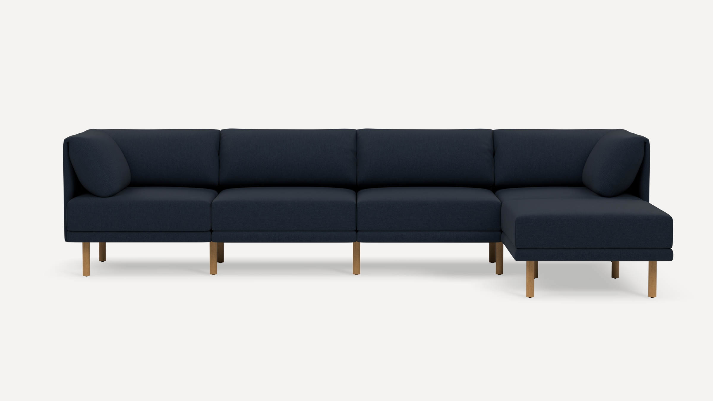 Modern navy blue sectional sofa with wooden legs, featuring a right-side chaise lounge and plush back cushions.