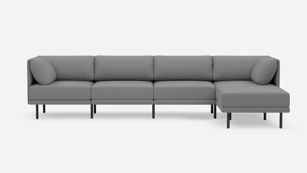 Modern gray fabric sectional sofa with clean lines, metal legs, and an extended chaise lounge on the right side.