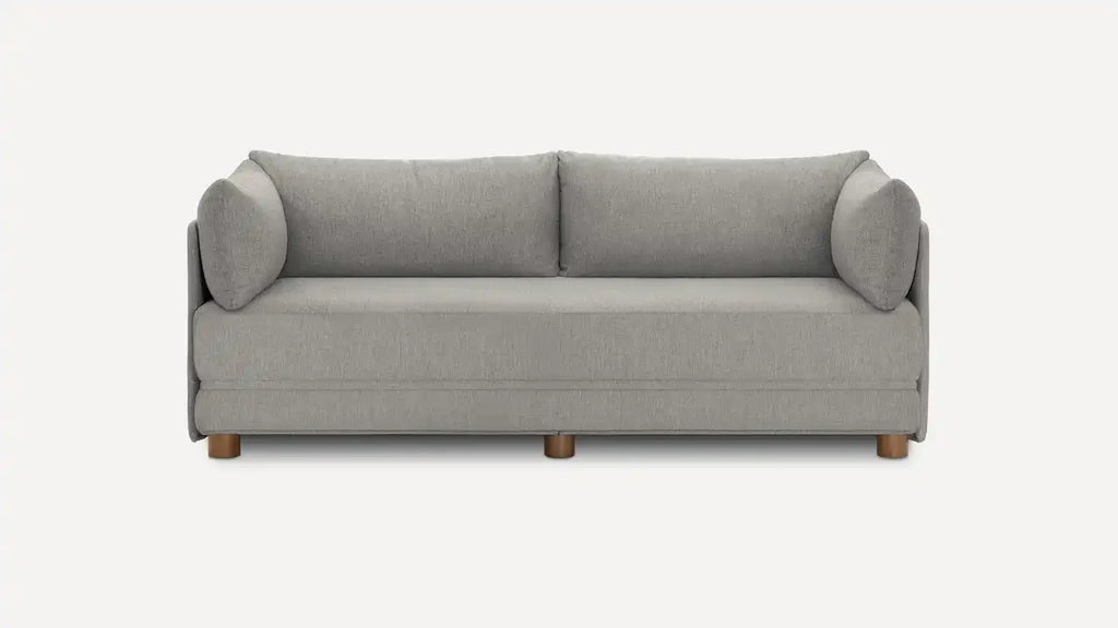 Modern three-seater sofa in light gray fabric with rounded armrests, loose back cushions, and wooden legs on a white background.