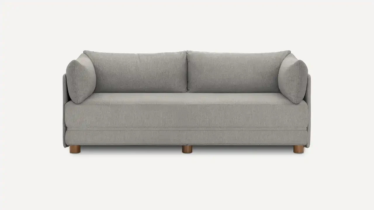 Modern three-seater sofa in light gray fabric with rounded armrests, loose back cushions, and wooden legs on a white background.