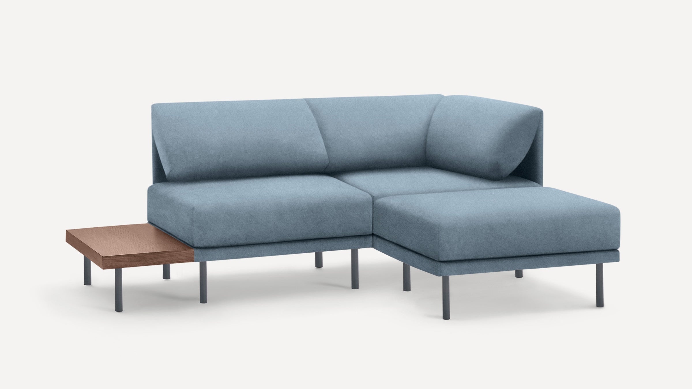 modern blue sectional sofa with chaise lounge and wooden side table on white background