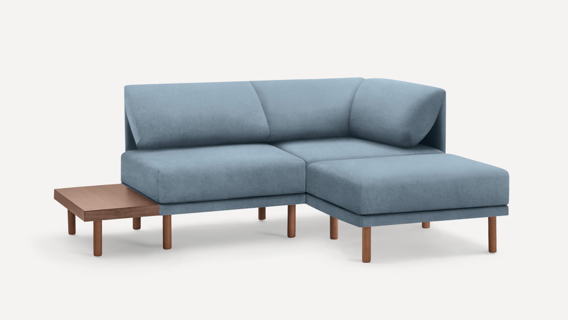 modern light blue sectional sofa with wooden legs and matching ottoman, featuring a clean, minimal design