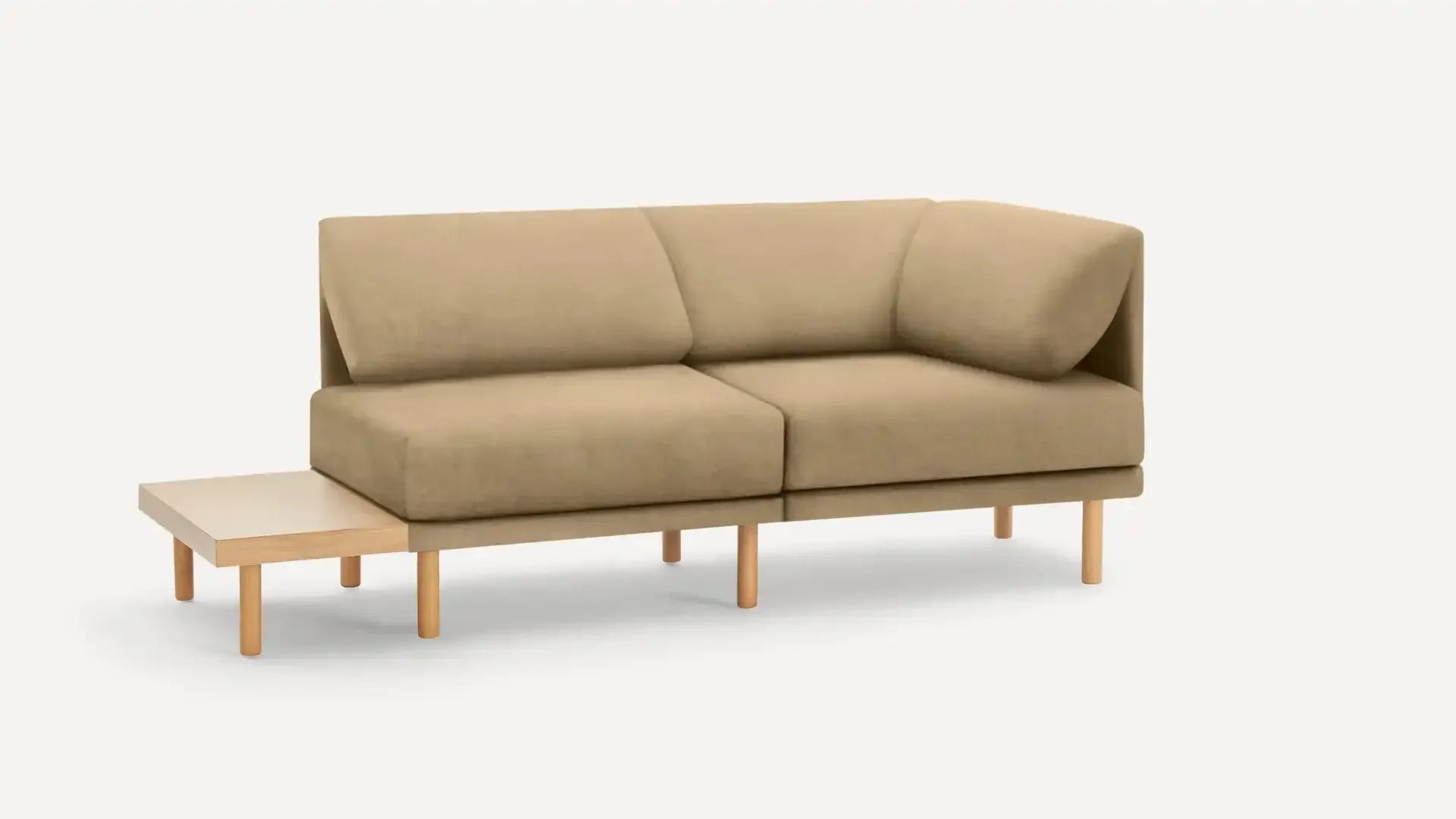 modern beige fabric sectional sofa with wooden legs and a matching ottoman on a white background