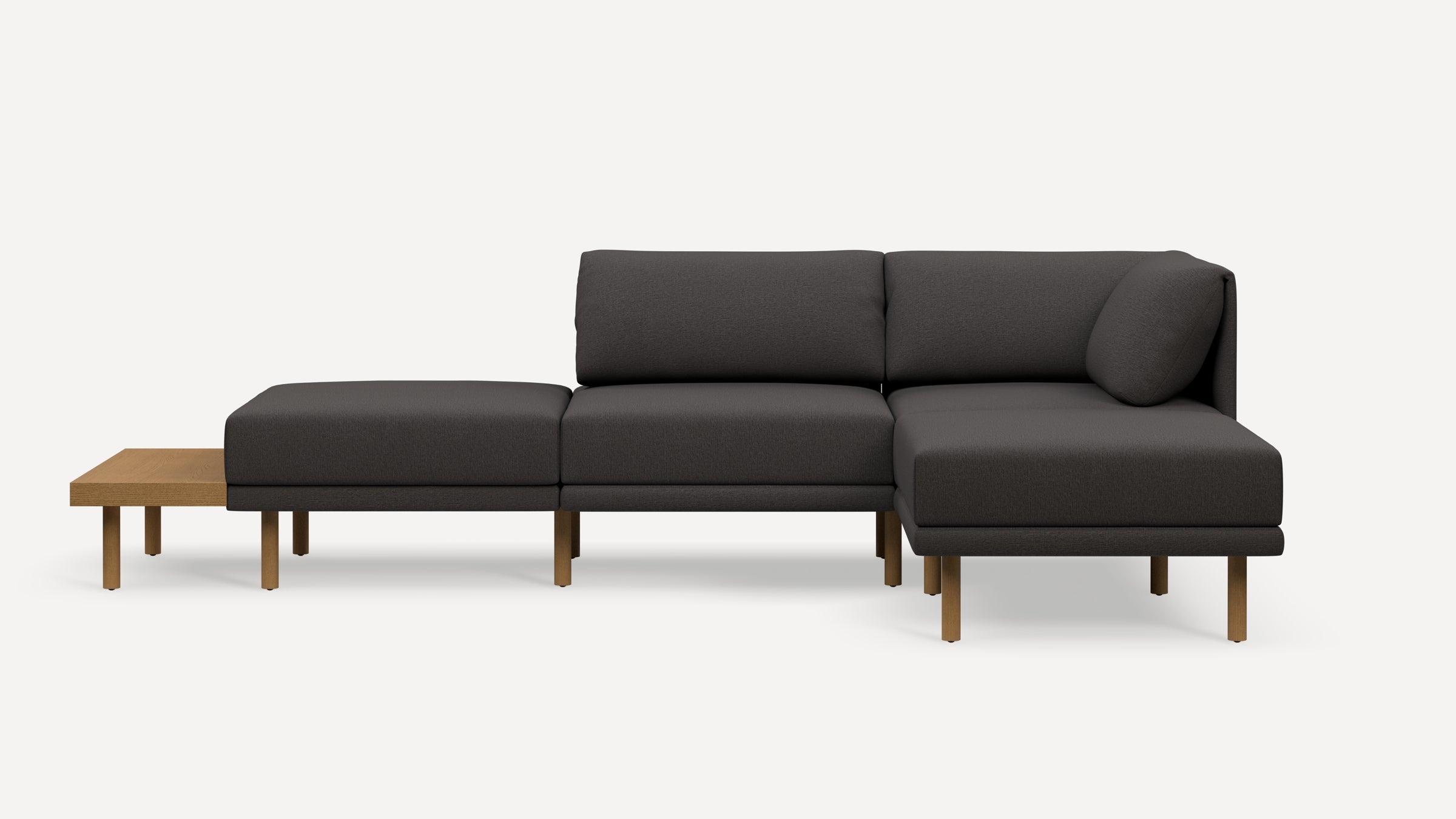 Modern dark gray sectional sofa with wooden legs and attached side table, featuring clean lines and minimalist design.