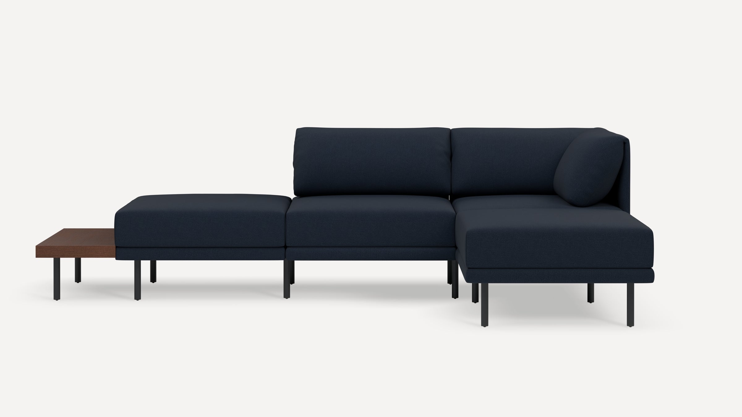 Modern navy blue sectional sofa with chaise lounge and minimalist black metal legs, featuring an attached wooden side table.