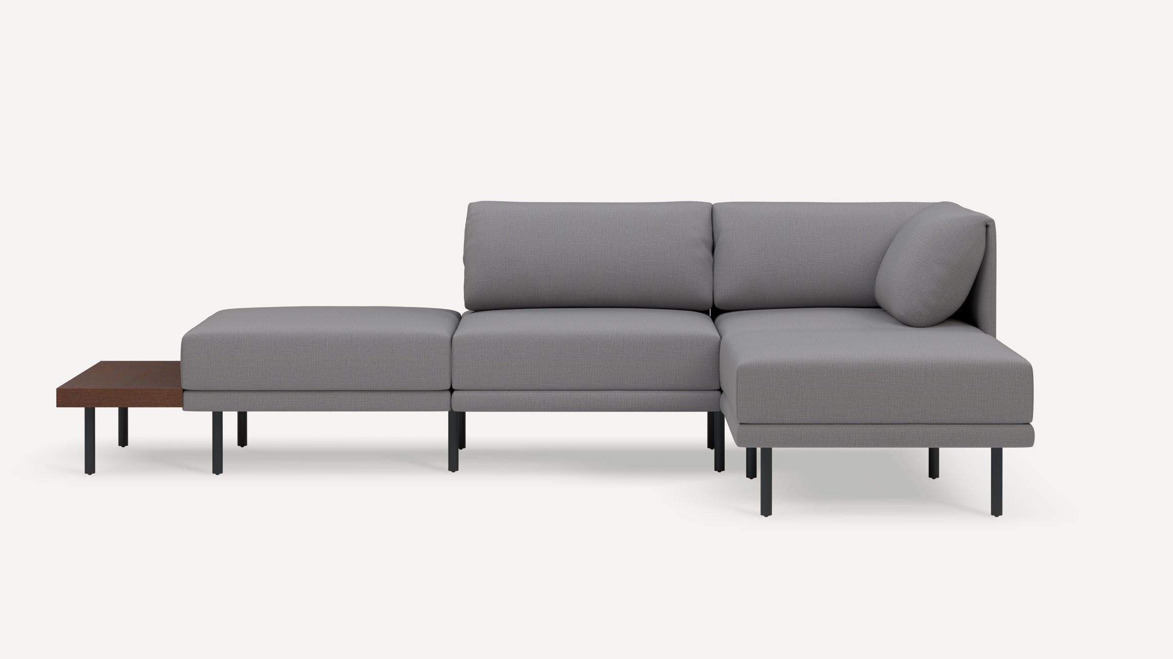 Modern gray sectional sofa with clean lines, slim black legs, cushioned seats, backrest, and an attached wooden side table.