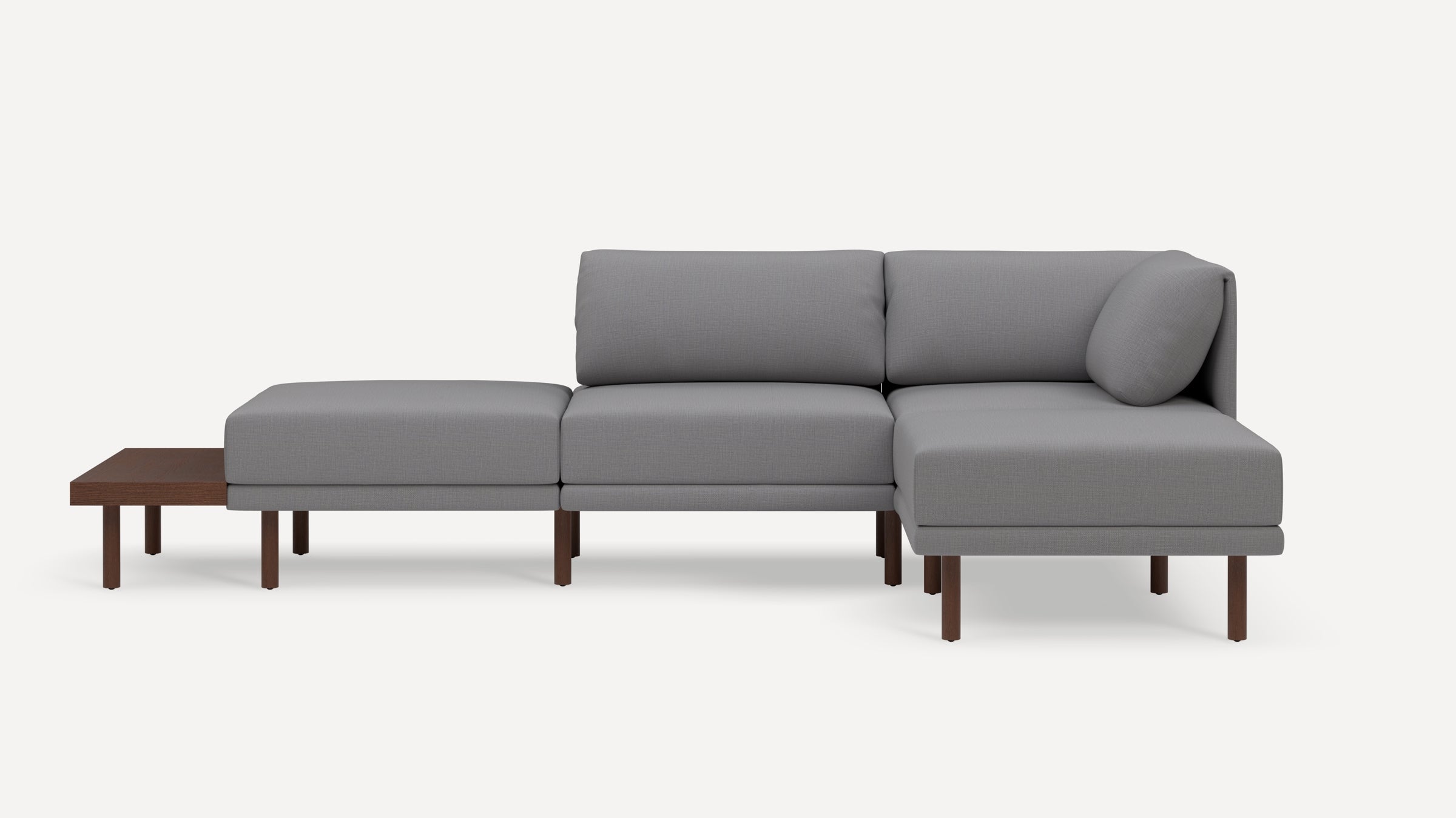 Modern gray sectional sofa with wooden legs and attached side table, featuring plush cushions and a minimalist design.